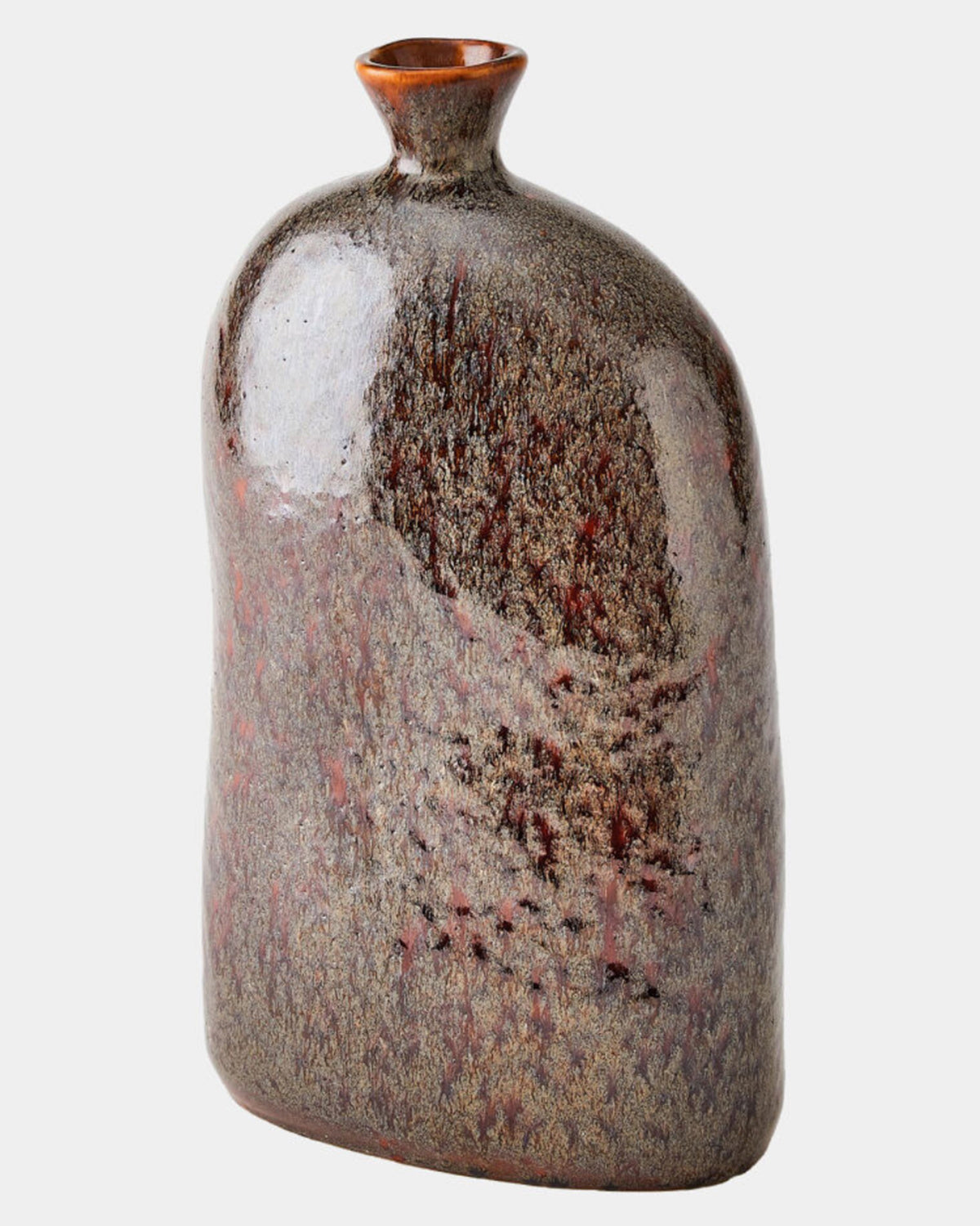 The Cinnabar Bottle S by Global Views is a ceramic vase with an irregular, asymmetrical shape and a narrow, tilted opening. Its mottled glaze in earthy browns, grays, and reddish tones evokes handcrafted Portuguese stoneware.