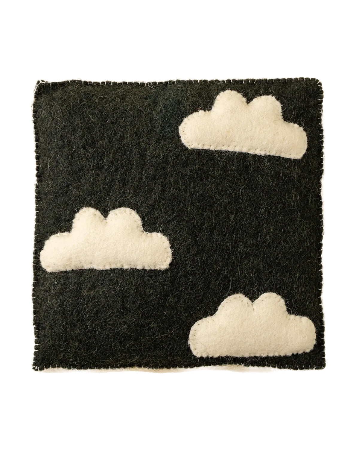 The Indaba Cloudy Day Wall Plaque features a rectangular black felt base with three white felt cloud shapes, creating charming handmade wall art or kids room decor. Shown against a plain white background.