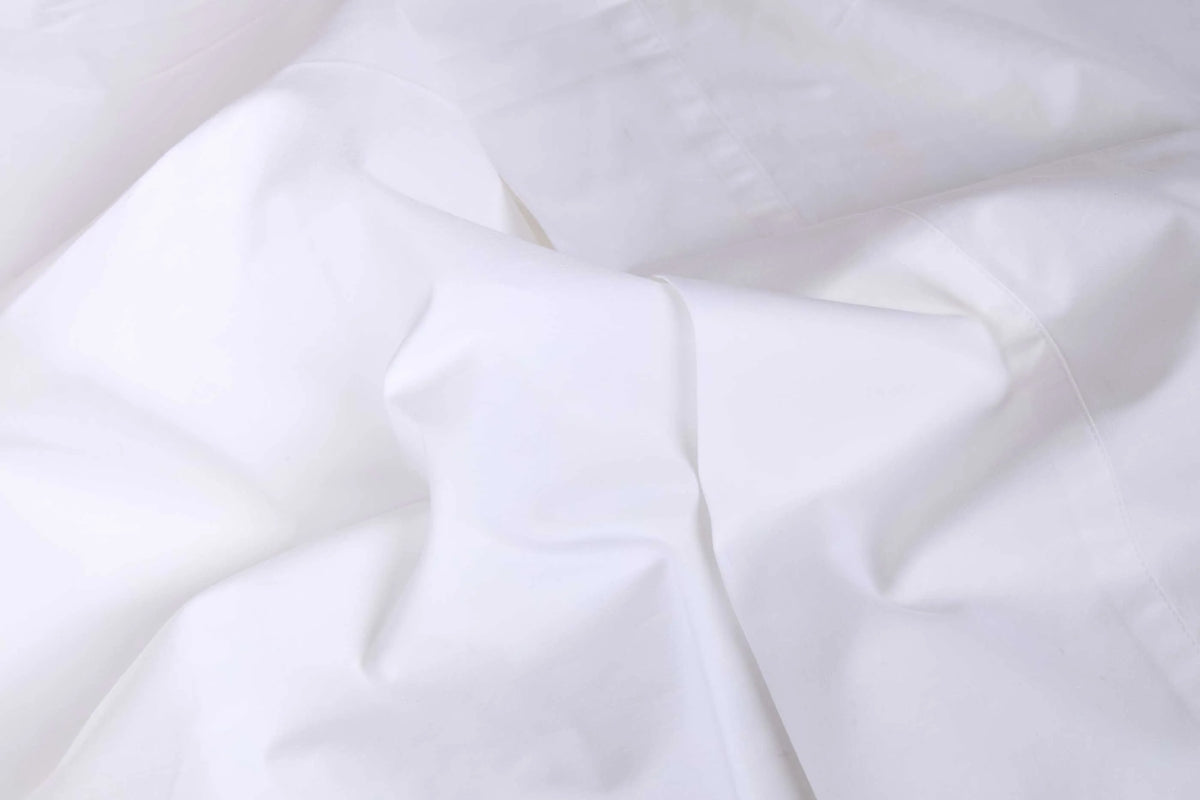 Twin cotton sateen sheet set with soft folds, smooth finish, and pom pom trim by Bungalow Furniture & Accessories.