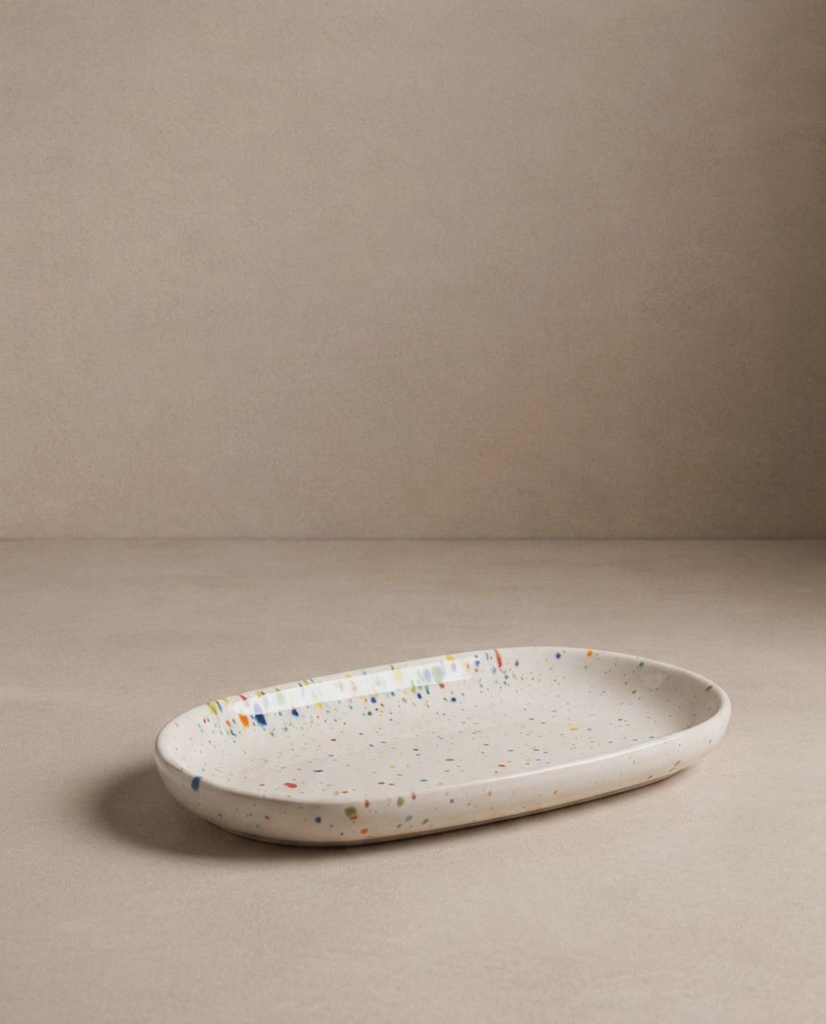 Oval Mini Tray by Bungalow Furniture & Accessories in white stoneware with a multi-colored speckled pattern.