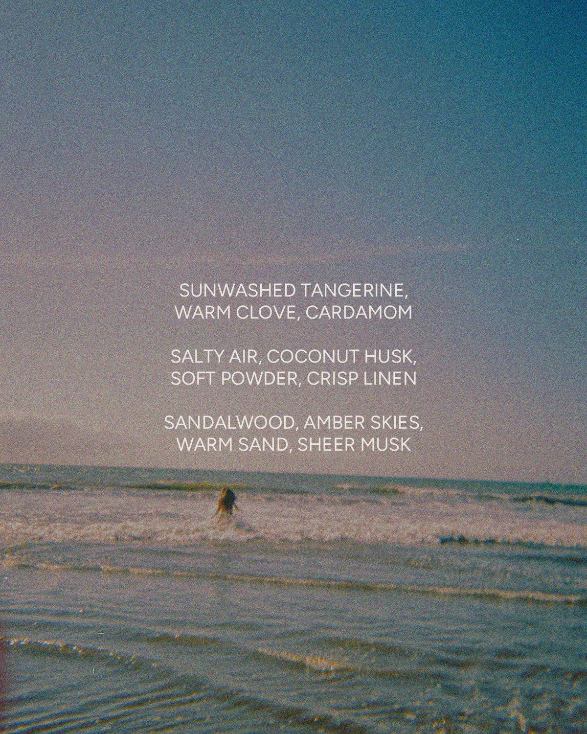 A person stands in shallow ocean waves under a blue sky. Overlaid text lists the fragrance notes of Faire’s SUNBURN 12 oz candle: sunwashed tangerine, warm clove, crisp linen, salty air, sandalwood, and sheer musk.