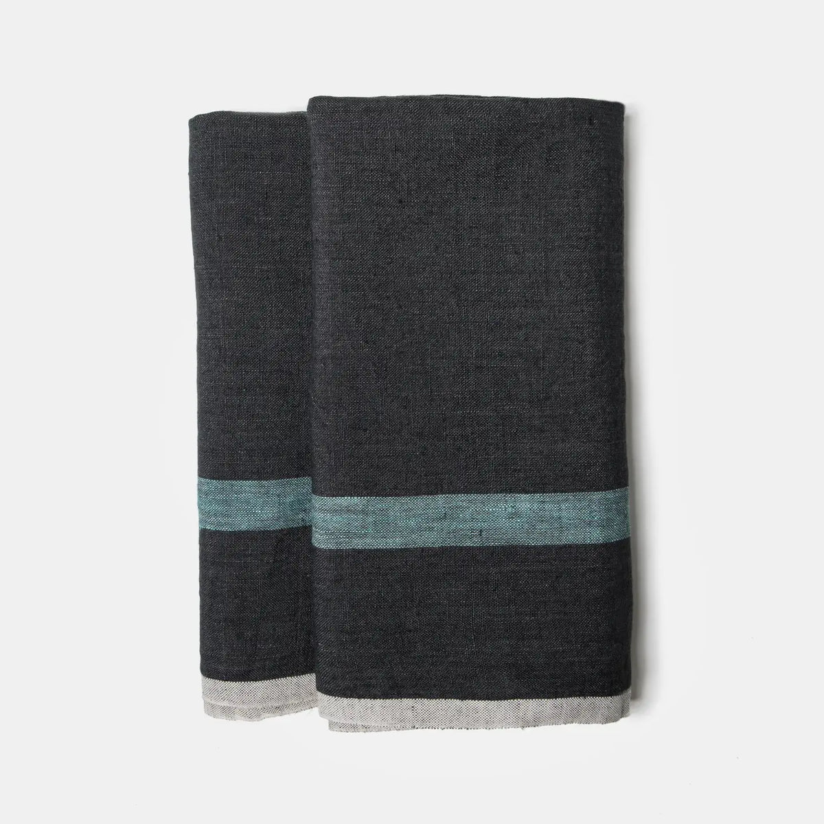 The CH Tea Towels S/2 by Faire feature dark gray linen with a horizontal teal stripe and thin light gray edge, shown folded side by side on a white background.