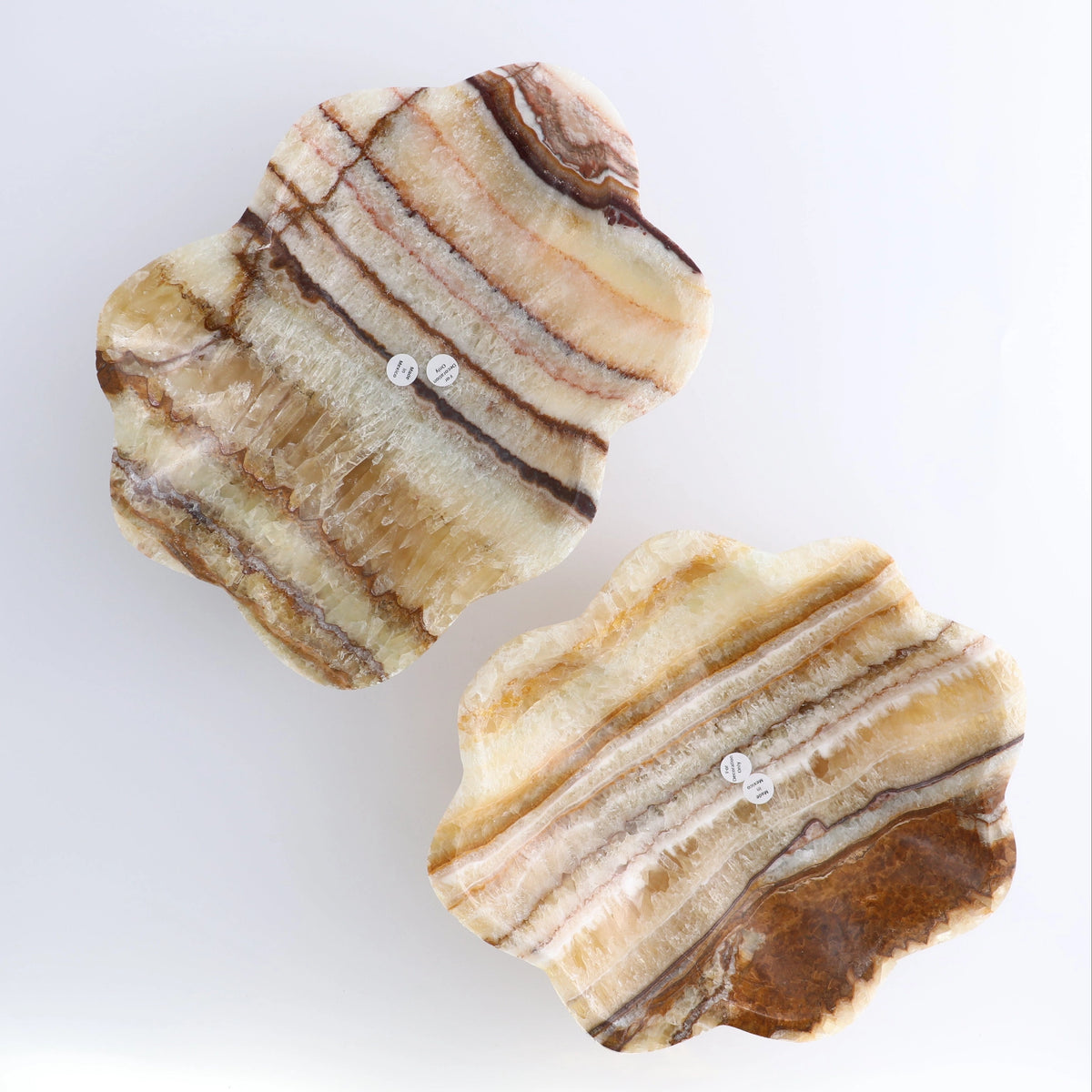 Two striped amber onyx/calcite mix slabs with earthy tones, Faire Bowl by Bungalow Furniture & Accessories.