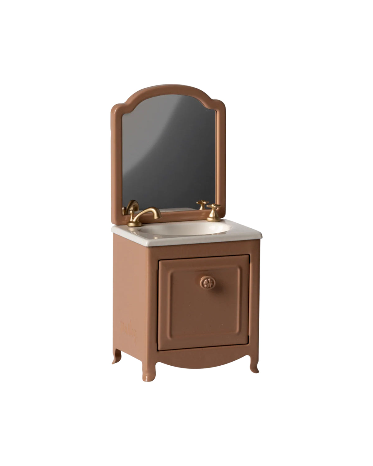 The Maileg Sink Dresser is a small brown dollhouse bathroom sink featuring a gold faucet, white countertop, cabinet door, and an attached rectangular mirror with rounded edges, shown against a plain white background.
