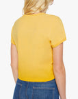 A person with long blonde hair is shown from the back, wearing Mother’s The Itty Bitty Ringer yellow 100% cotton short-sleeve t-shirt and blue jeans against a plain white background.