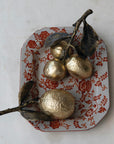 Ceramic lemon figurines with leaves on a floral plate by Creative Co-op, perfect decorative accent for any room.