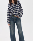 Denimist cropped work shirt styled with wide-leg jeans and loafers, modern casual look against white background.