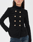Denimist Shrunken Officer Jacket and jeans styled on a woman with sunglasses against a light backdrop.