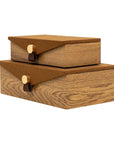 Two stacked Harriett Box wood grain storage boxes with brown fabric lids and gold button closures by Bungalow.