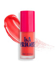 A bottle of Faire 03 Water Lip Balm Shade with a bright red-pink cap sits before a swatch of its vibrant red-pink color on a white background, showcasing a fresh, matte finish.