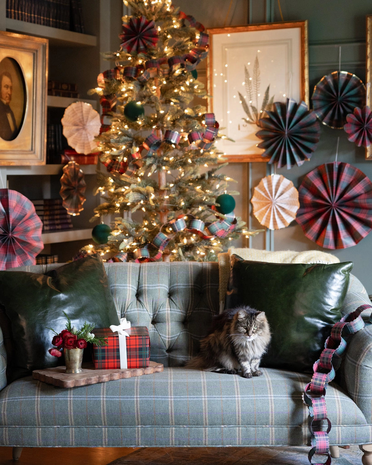 20ft Red and Green Plaid Christmas Paper Chains draped over a Bungalow Furniture & Accessories tufted sofa.