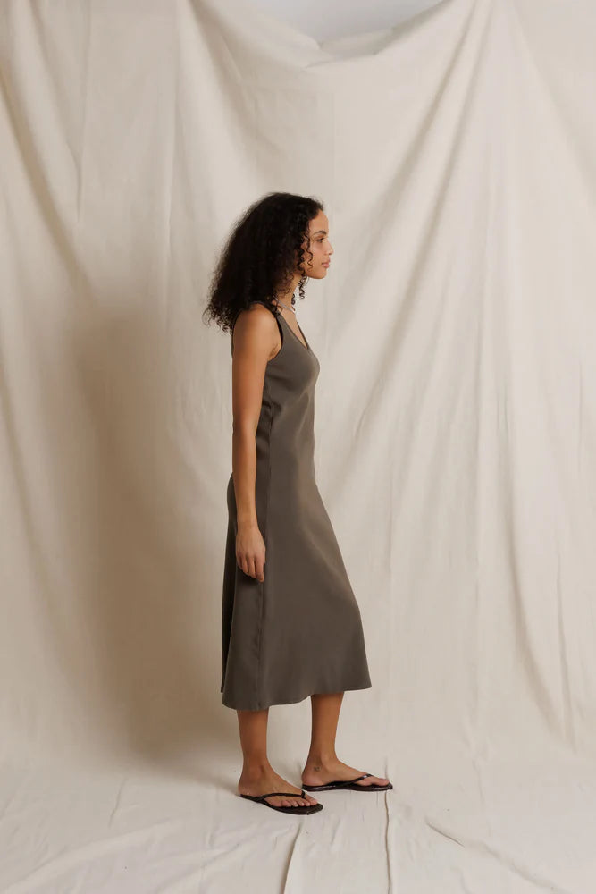 Edith Heavy Rib Midi Tank Dress by Perfectwhitetee in cream, ribbed texture, shown in profile against fabric backdrop.