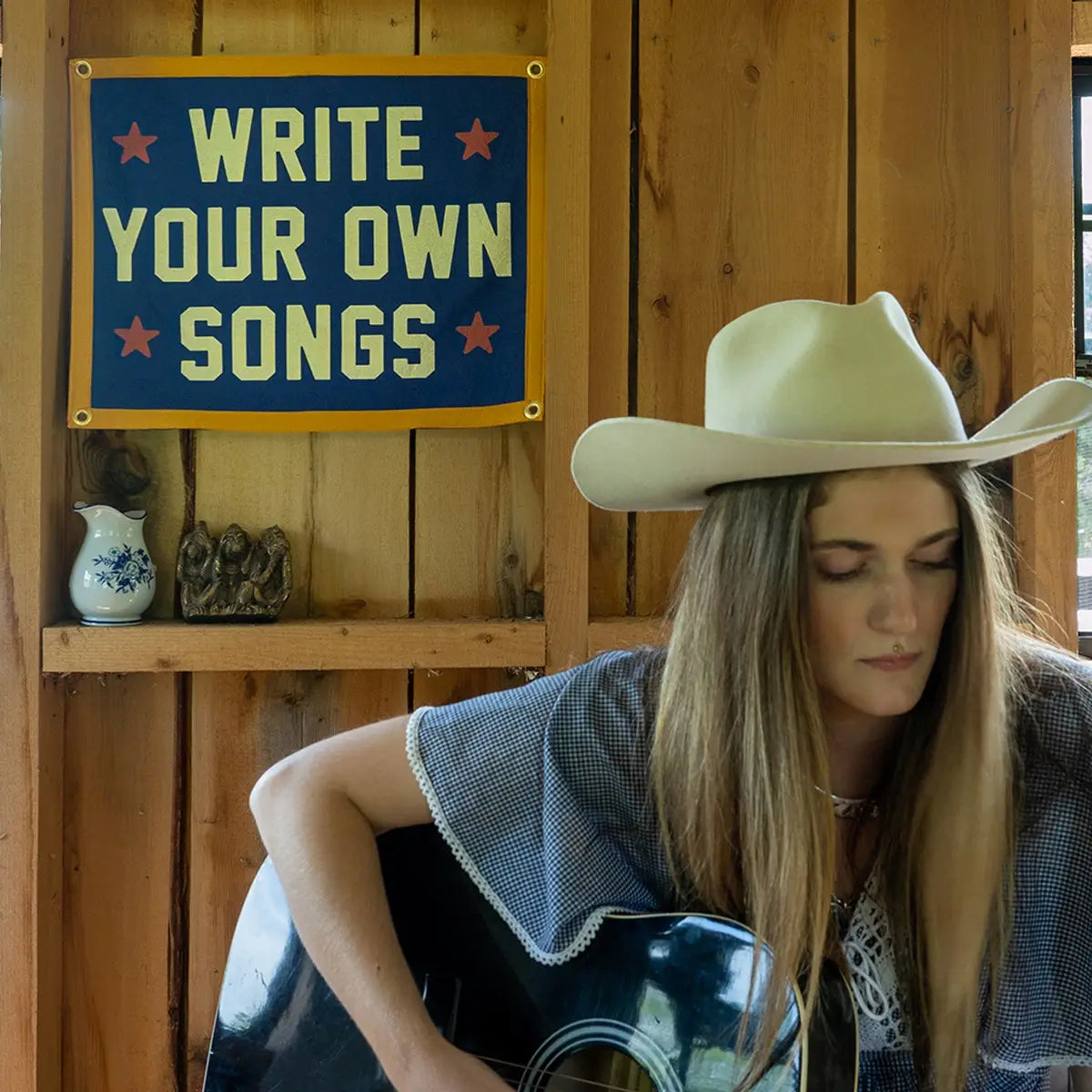 Cowboy-inspired decor with rustic wood accents in a cozy music room, Bungalow Furniture &amp; Accessories style.