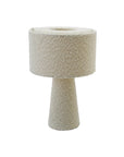 The Bloomingville Bouclé Ivory Fabric Table Lamp features a modern cylindrical base and drum-shaped shade in textured cream bouclé, set against a white background.