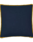 The Fairuza Embroidered Pillow by Eastern Accents is a square navy blue linen decorative pillow with mustard yellow fringe trim, displayed against a white background.