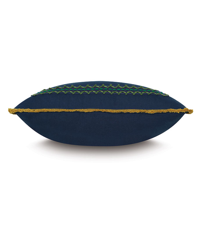 The Fairuza Embroidered Pillow by Eastern Accents features a navy blue linen base with green and blue embroidery and yellow-gold fringe, displayed from the side against a white background.