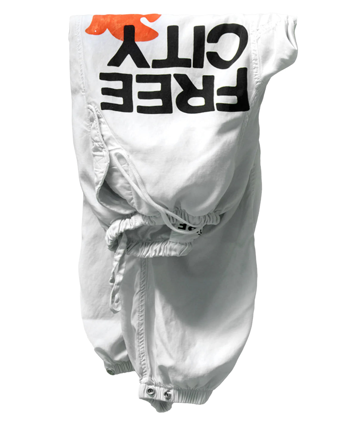 The Flap/Snap AirJump Pant by Free City (sparrow, LLC) features a white unisex satin design with elastic waistband and cuffs, custom sunfade wash, bold black FREECITY print, and an orange graphic, shown upside down on a plain white background.