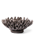 The Fractal Black Flower by Faire is a handmade pottery bowl with an intricate, floral-inspired design and wavy petal edges, displayed against a white background.