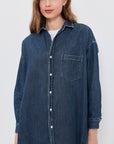 Frank & Eileen Shirley oversized dark indigo distressed denim button-down shirt worn by a woman.