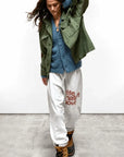 SuperYumm Norwegian Wool Pocket Cardi in blue layered under an olive utility jacket with white logo sweatpants.