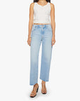 A person in The Dodger Ankle loose straight leg jeans by Mother, paired with a white sleeveless top and clear high-heeled sandals, stands against a white background.