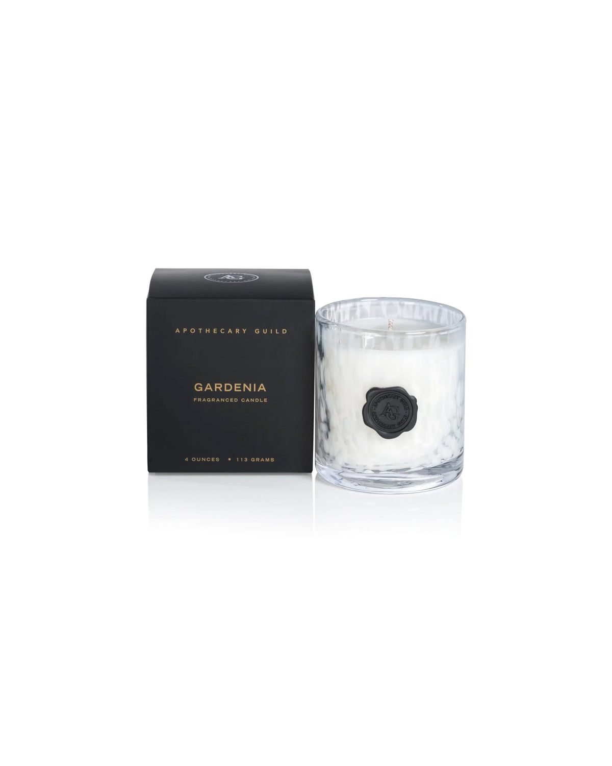 A clear glass IG-2855 Opal Candle Gardenia 4oz by Zodax, with a black wax seal and white wax interior, sits beside a sleek black box—ideal for those who love luxury scented candles.