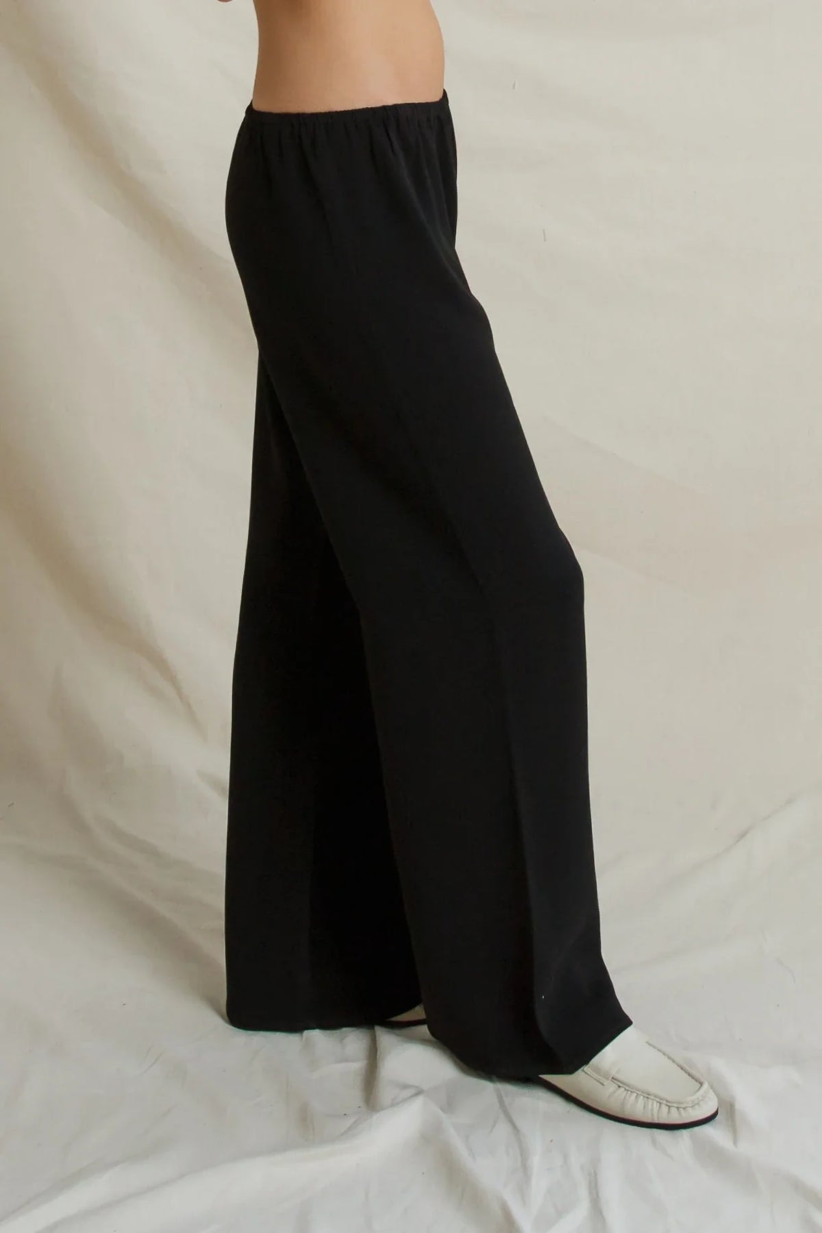 Georgia Crepe straight-leg pull-on pants in black paired with white loafers.