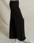 Georgia Crepe straight-leg pull-on pants in black paired with white loafers.