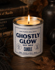 Ghostly Glow soy candle by Bungalow Furniture, glowing warmly among vintage books and autumn decor for a Halloween vibe.