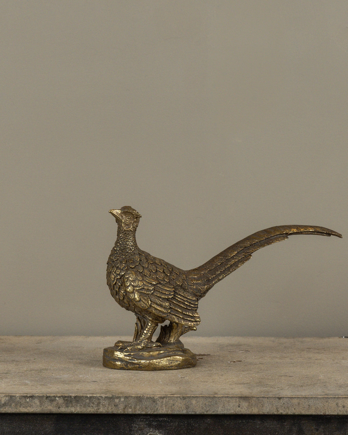 Gold pheasant statuette by Faire on round base, elegant metallic accent for shelves or decor displays, 27.9 cm tall.