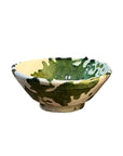 Shallow ceramic bowl with green splatter glaze on a cream base, Moroccan-inspired, by Faire.