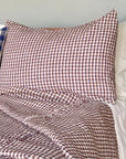 Hertford King Duvet by Plum Textiles on bed with plaid brown, white, blue blanket and check accent pillow.