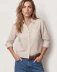 Taupe and white striped boxy crop LS shirt with No Gape buttons by THE SHIRT, styled with blue jeans.