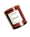 A brown glass HONEYPUNK 12 oz candle by Faire features a white label and sits against a white background. This non-toxic, vegan candle is crafted for mindful ambiance.