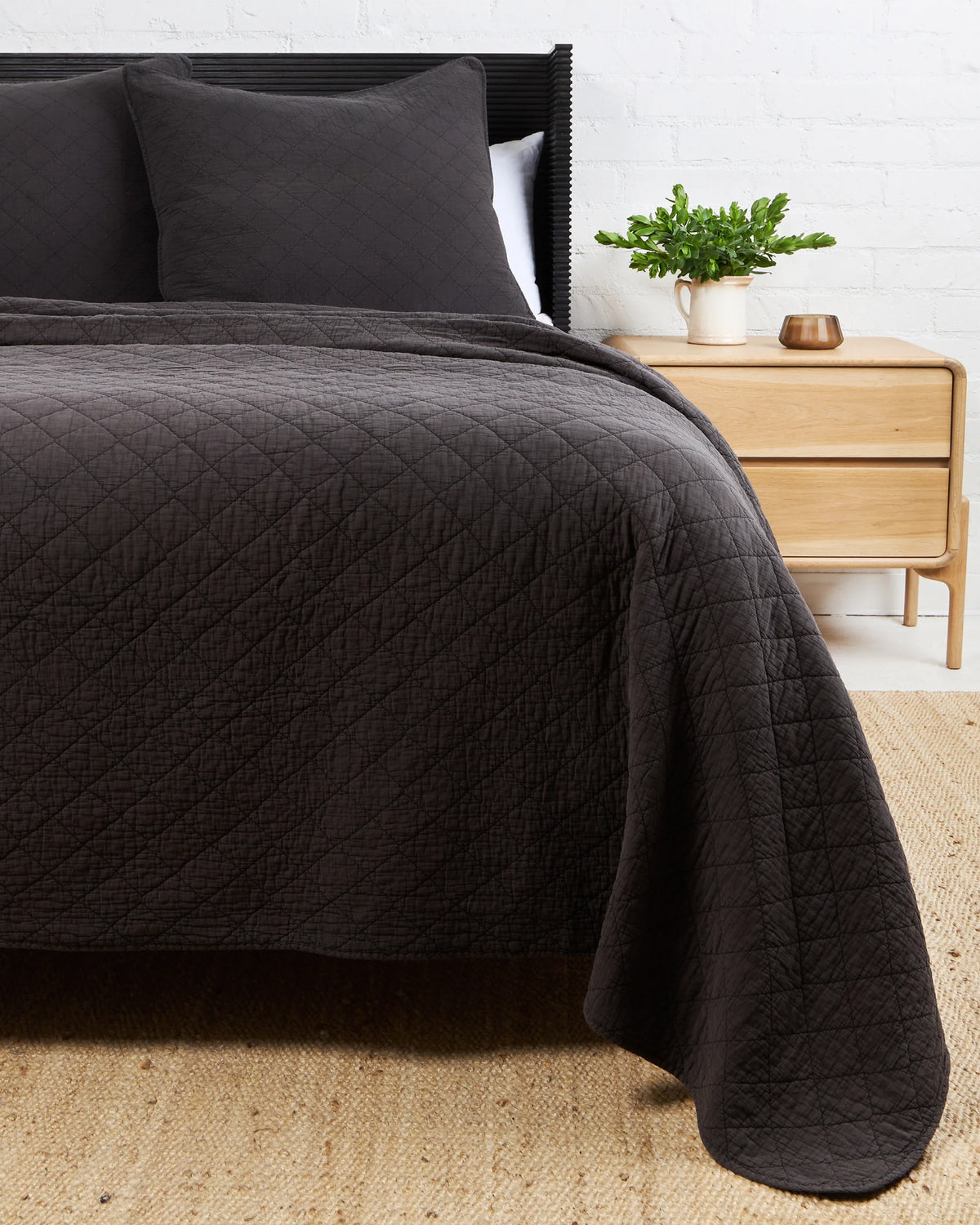 King diamond quilt coverlet set with pillows by POM POM Huntington, styled beside a nightstand and plant.