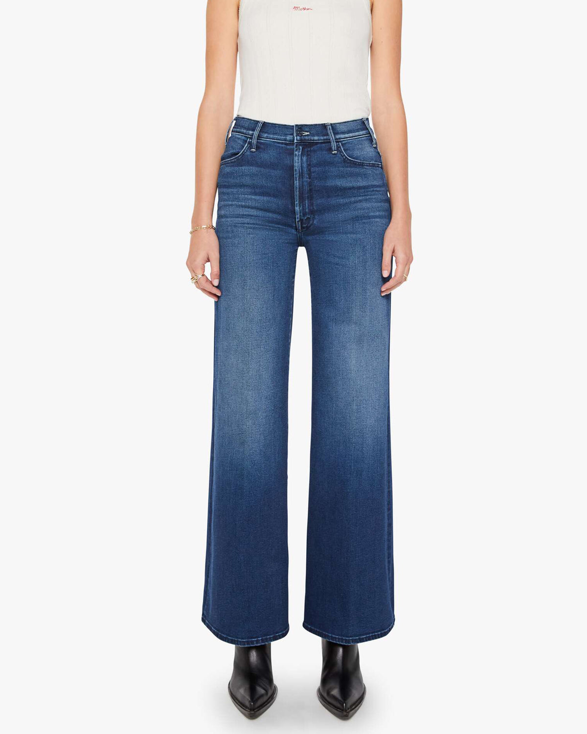 Blue stretch denim jeans with black boots, Mother brand, The Hustler Roller Sneak style, shown from shoulders down.