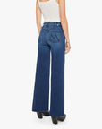 Mother’s The Hustler Roller Sneak jeans in blue denim, styled with a white tank top, model shown from the back.