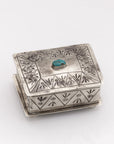 The J Alexander Rustic Silver 15-4-T Small Stamped Box w/ Turquoise features engraved geometric patterns and a turquoise stone centerpiece, adding Southwestern charm to any space. Shown on a plain white background.