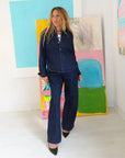 Keaton Denim Shirt by Kerri Rosenthal in a bright, modern room with colorful abstract art and white walls.