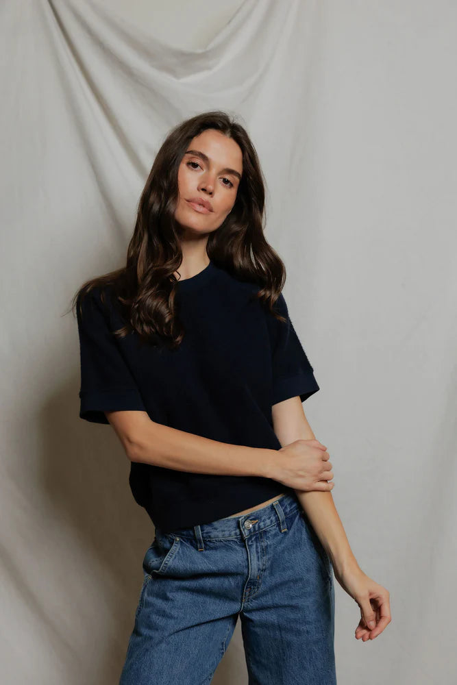 Kennedy SS Crew Sweatshirt by Perfectwhitetee styled with blue jeans, shown against a draped white backdrop.