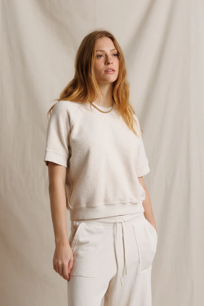 Kennedy SS Crew sweatshirt by Perfectwhitetee in beige, worn by model against a neutral fabric backdrop.