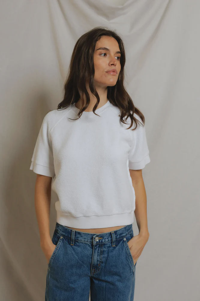 Kennedy SS Crew Sweatshirt by Perfectwhitetee in a casual look with blue jeans, hands in pockets, looking aside.