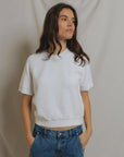 Kennedy SS Crew Sweatshirt by Perfectwhitetee in a casual look with blue jeans, hands in pockets, looking aside.