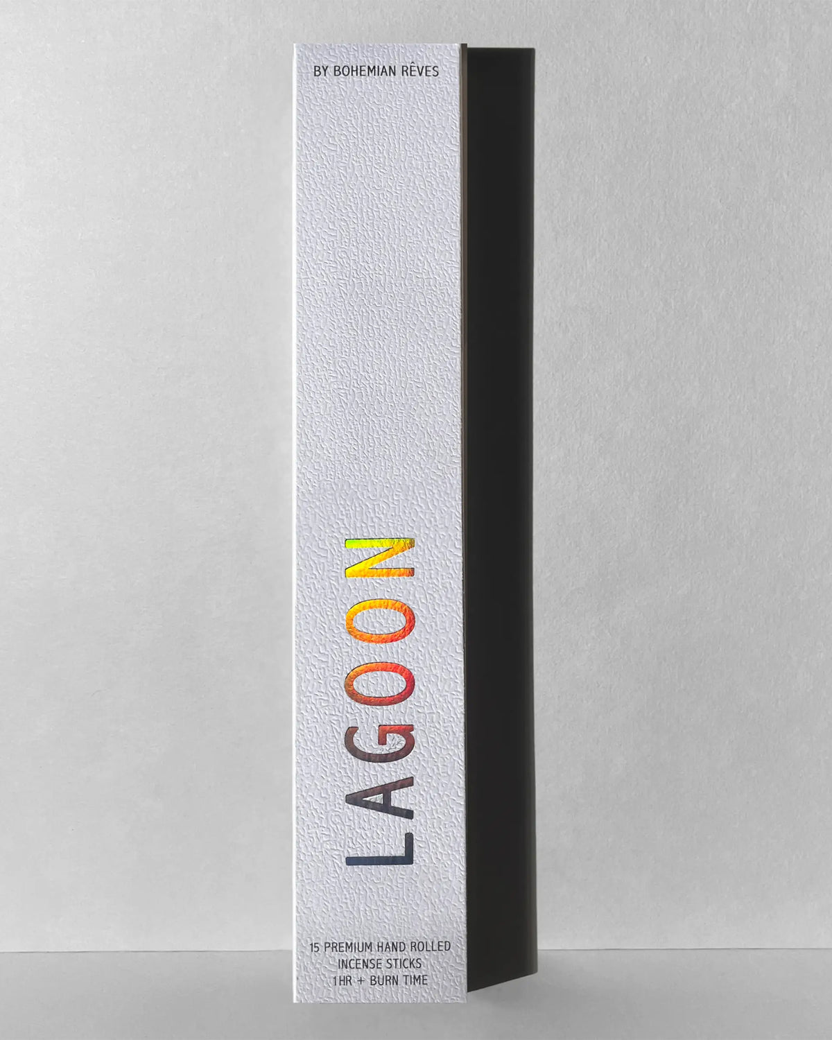 A tall, rectangular white box labeled "Lagoon Incense Sticks | Lush & Seductive" in colorful letters. The luxury Faire packaging notes "5 premium hand rolled clean-burning incense sticks," casting a shadow on a gray background.