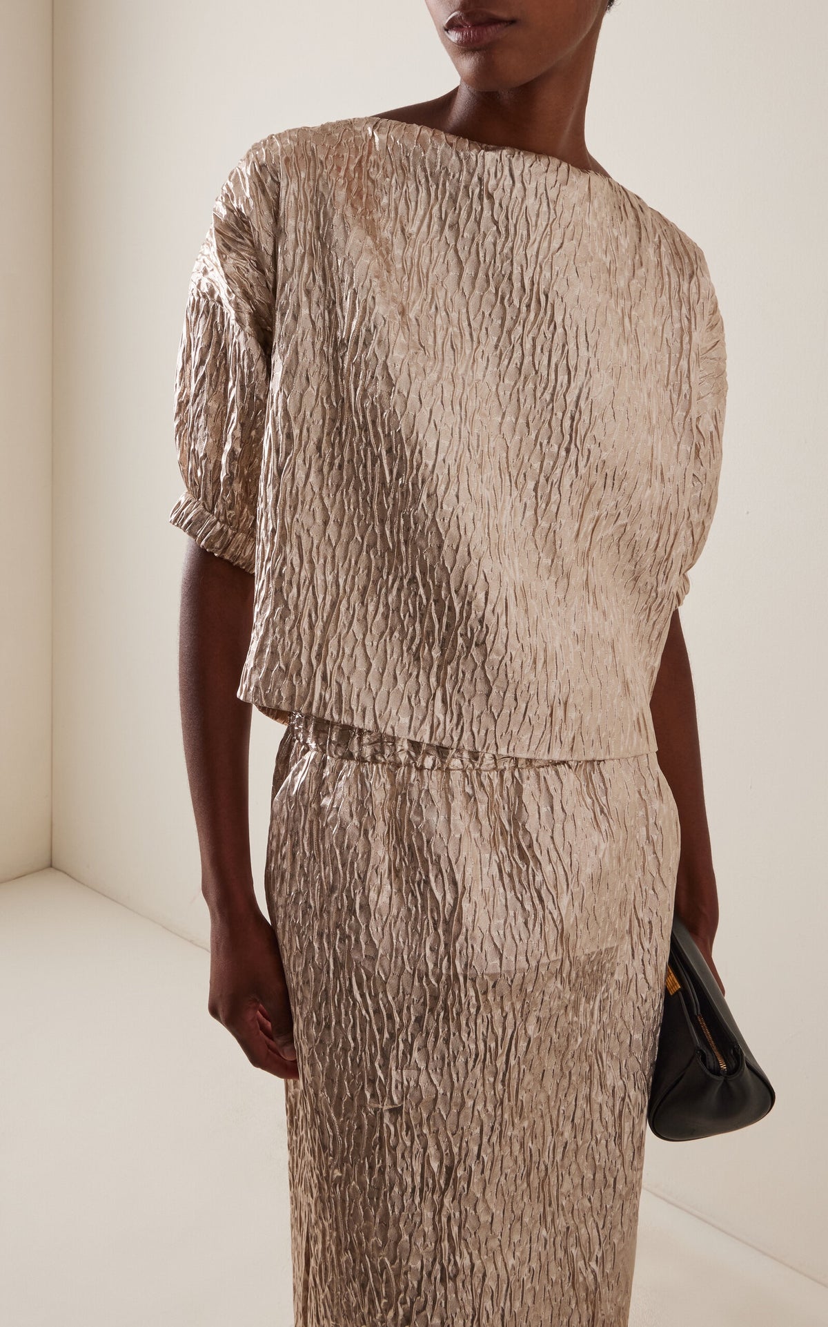 Rachel Comey Filly Top styled with a black clutch against a light neutral backdrop, modern and minimal look.