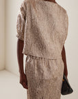 Rachel Comey Filly Top styled with a black clutch against a light neutral backdrop, modern and minimal look.