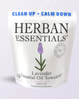 A resealable pouch labeled "Faire Lavender Towelettes - 20 Individual Essential Oil Wipes" features a lavender flower, purple and black text, and phrases "Clean Up · Calm Down" and "New Recycled & Recyclable Bags," highlighting calming wipes.