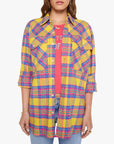 Lazy Sunday oversized plaid button-up worn over a pink graphic t-shirt and blue jeans.