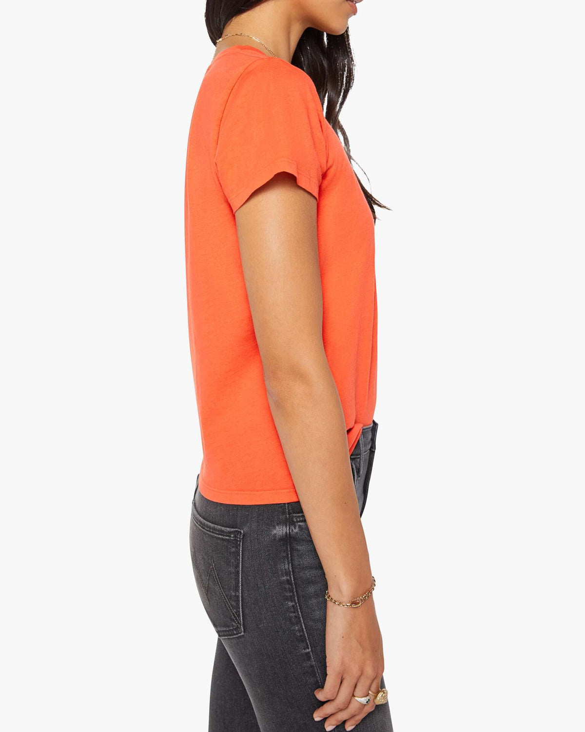 Black jeans and The Lil Goodie Goodie Tee by Mother styled for a retro look, model posed against white backdrop.