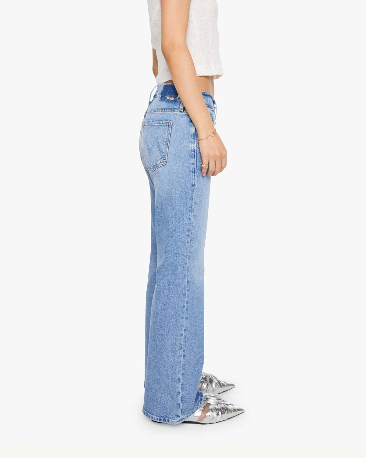 Light blue high-rise Mother Lil Jinx Sneak straight-leg petite jeans in a side view.